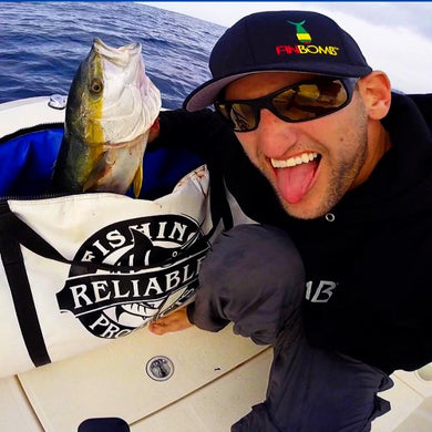 man taking a selfie with tongue out with fish 