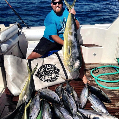 bearded man in sunglasses posing with fish next to fishing kill bag
