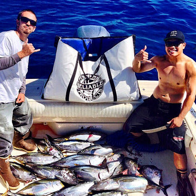 2 men posing with fish caught that day nexy to fish kill bag